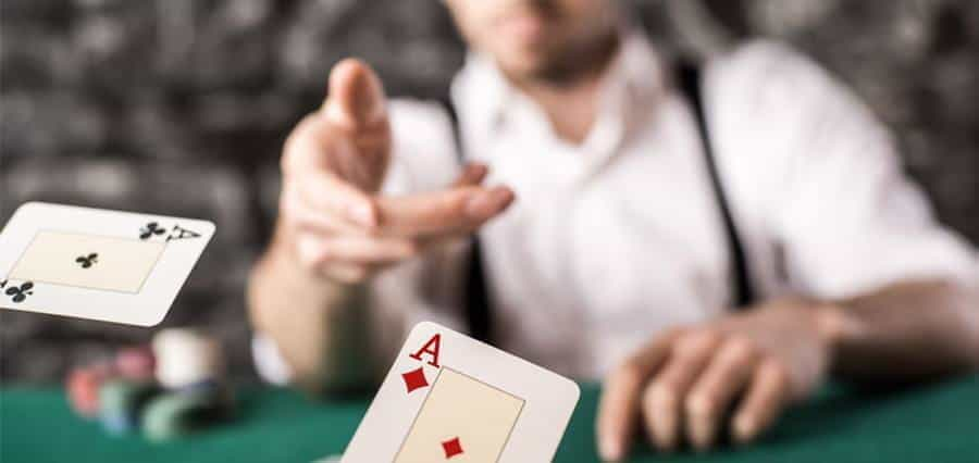 A man flicking a card towards the camera.