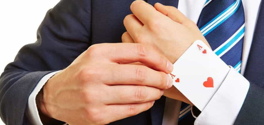 A man hiding a playing card in his sleeve.