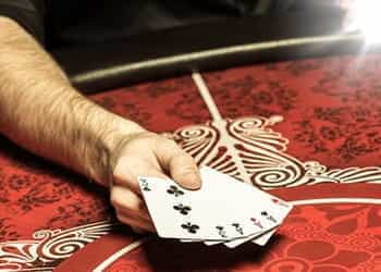 A hand of cards of a table.