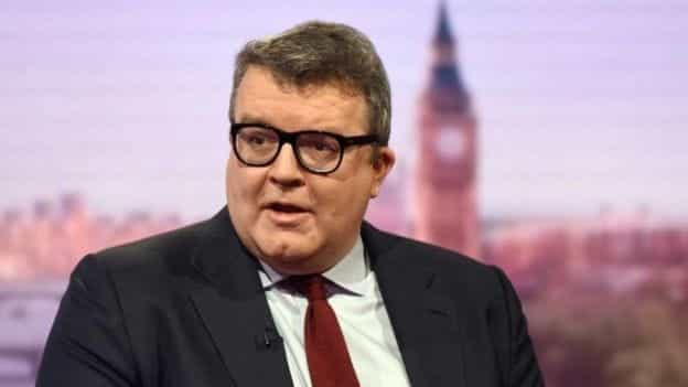 Tom Watson in front of a London skyline.