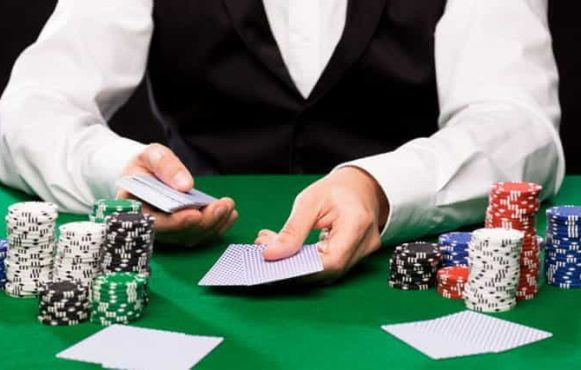 A casino croupier dealing cards.