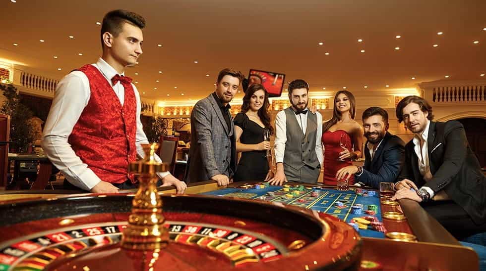 A casino roulette game with players and a croupier.