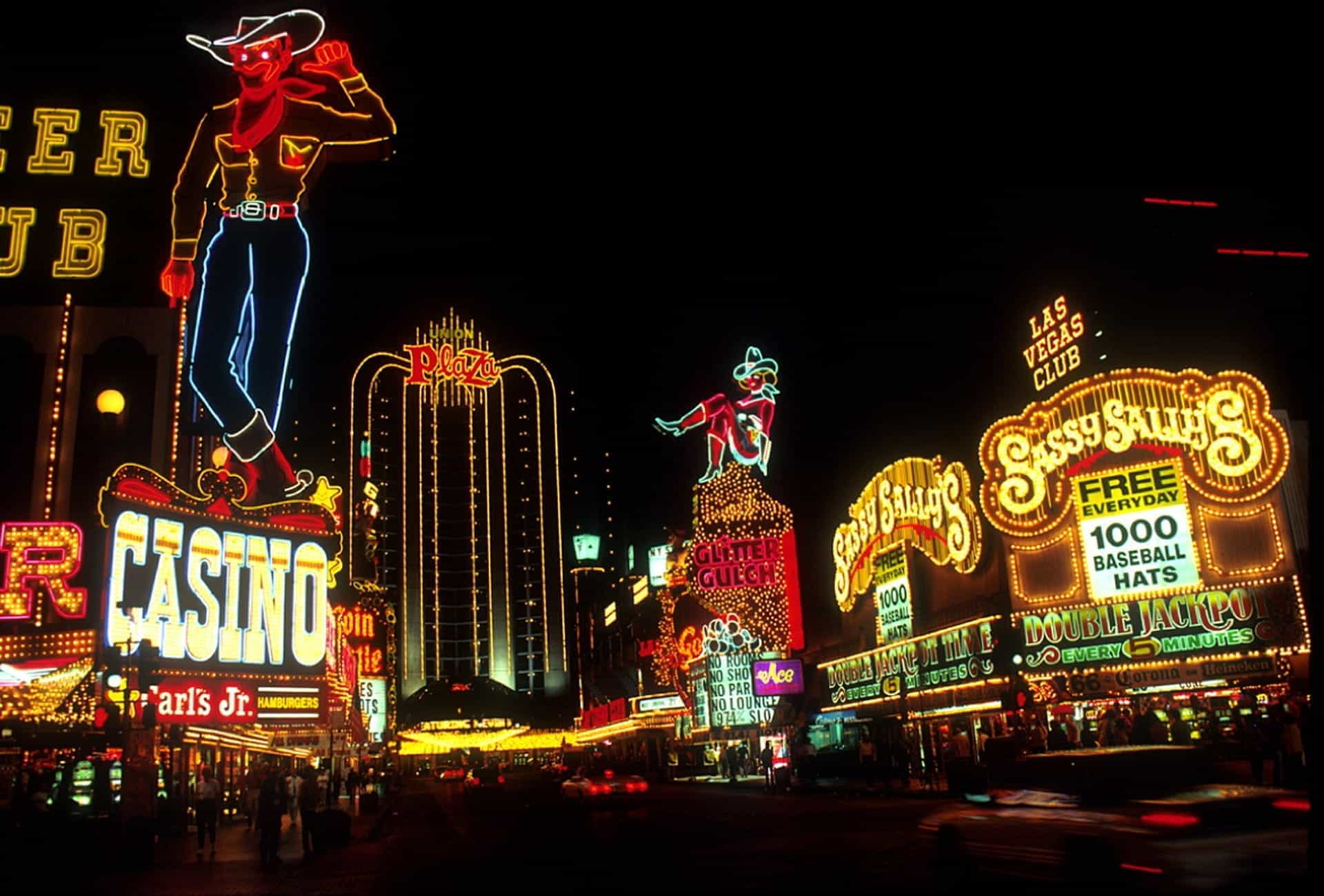 A view of Las Vegas strip at nighttime, lit up with neon casino signs