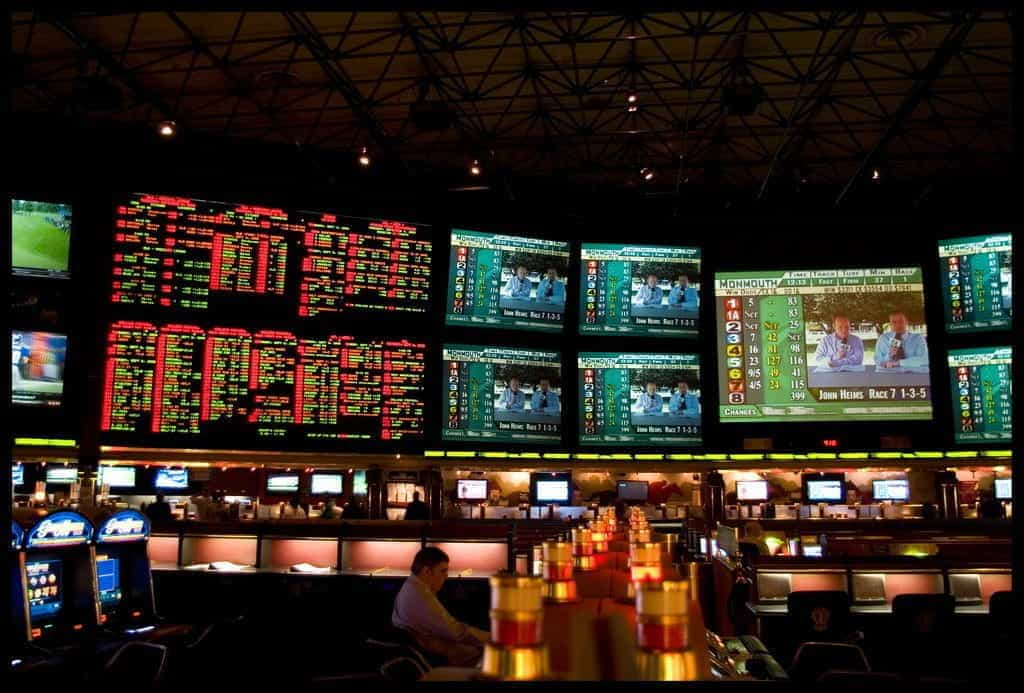 A sports betting kiosk with statistics, gameplay and odds displayed on screens.