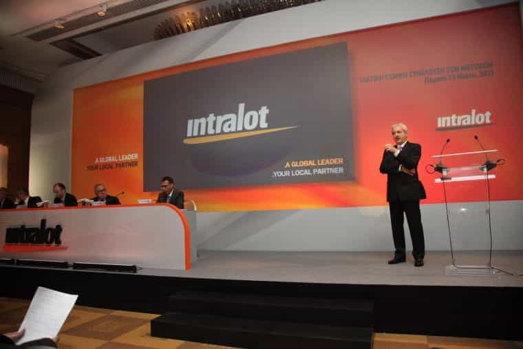 Speakers on stage at an Intralot event.