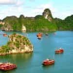 Vietnamese coastline with rocky outcrops and boats.