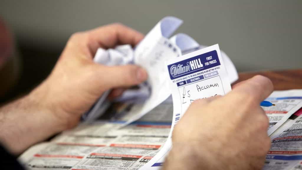 Close up of someone placing a bet on a William Hill betting slip.