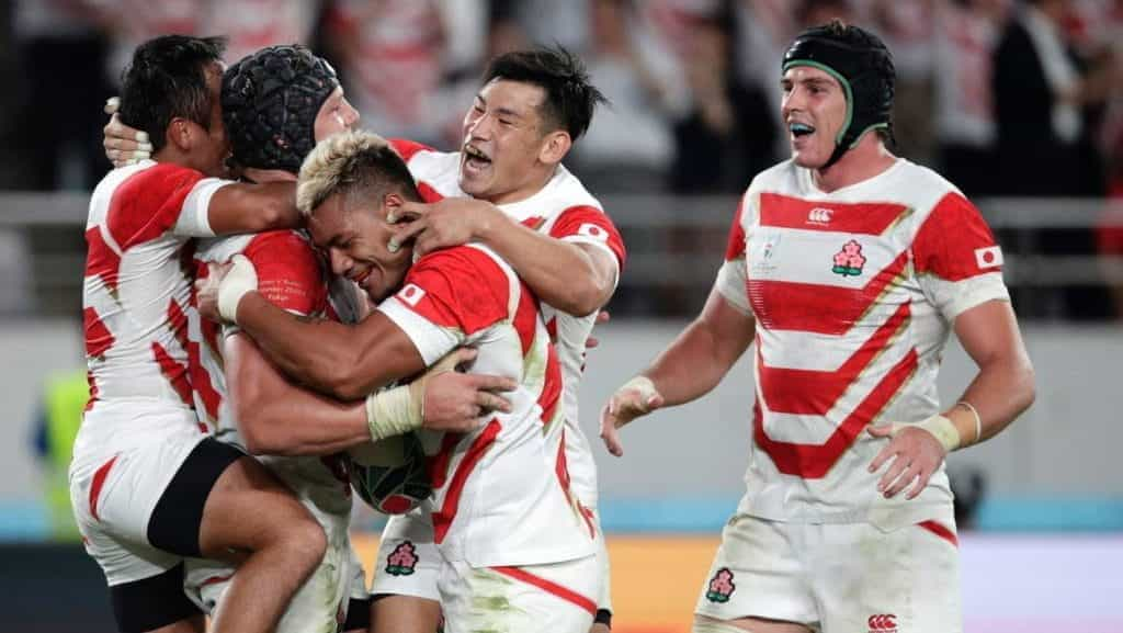 Japan’s players celebrate after a try is scored by teammate.