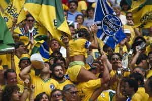 A massive crowd of screaming fans in Brazil at a football game. 