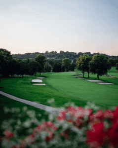 An overview over part of a golf course on a sunny day.