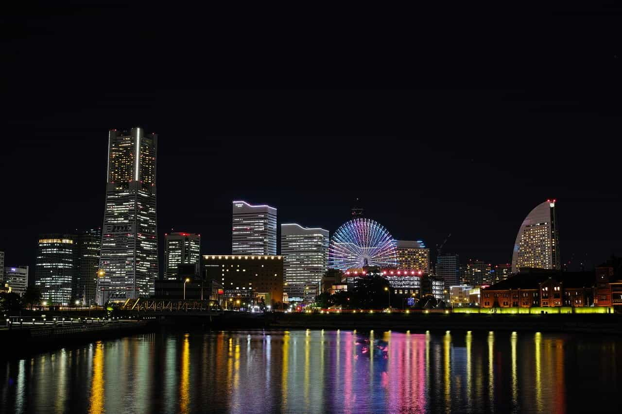 The skyline of Yokohama seen at night from the other side of the river.