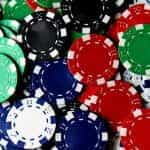 Close up of many poker chips in different colors.