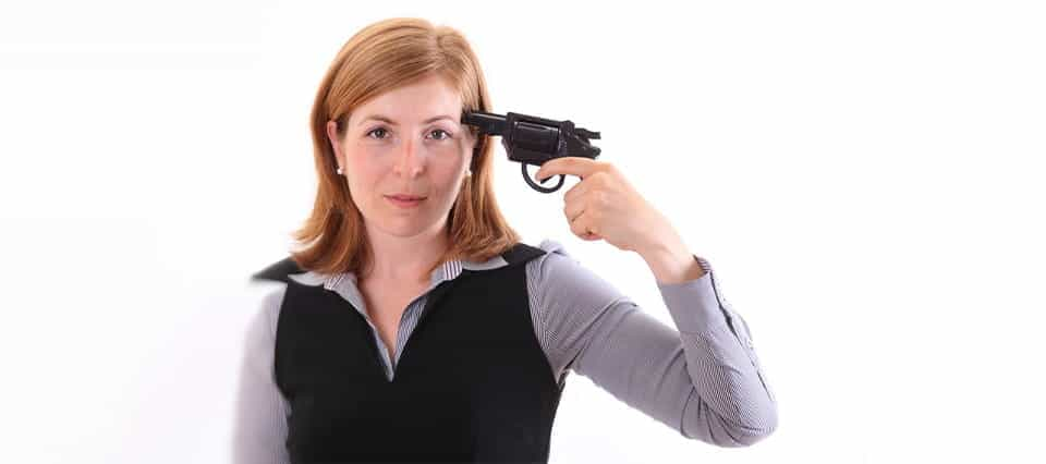 A woman holding a gun to her head.