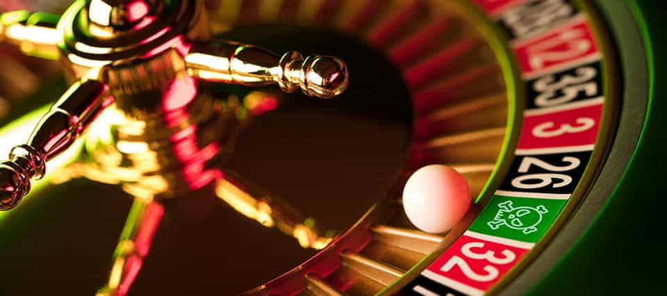 A roulette wheel, with the white ball landing in a pocket labelled not with a number but with a skull.