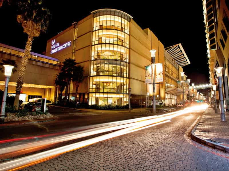 The Sandton Convention Centre seen from the street at twilight.