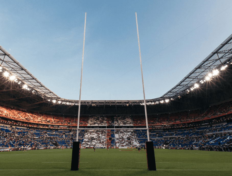 A view of an NFL field from behind the goalposts.