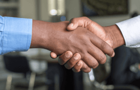 Two businessmen shake hands in a deal.