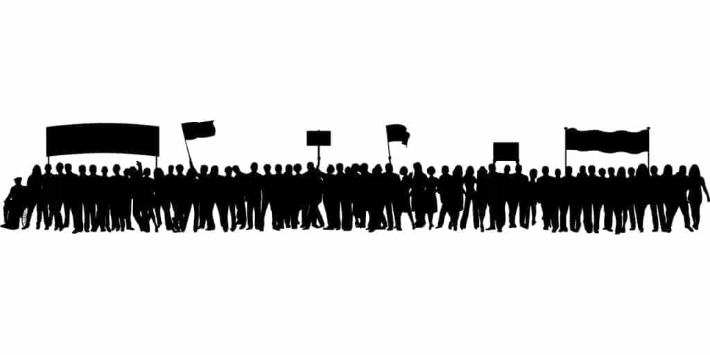 A black silhouette of a crowd protesting. 