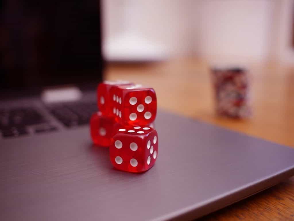Stack of dice on top of a laptop.