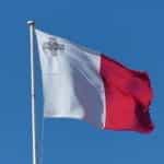 The Maltese flag flying from a flagpole.