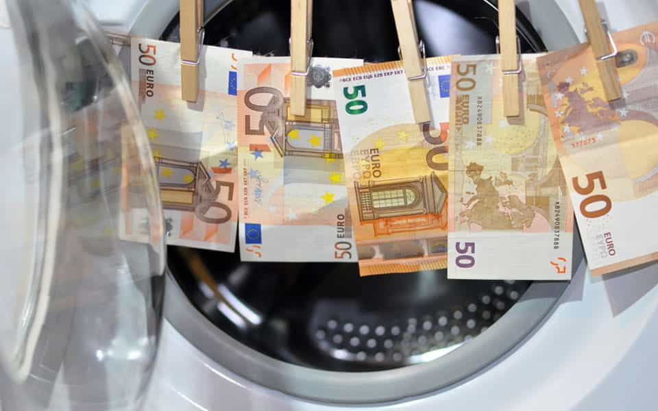 Euro notes, hung up in front of a washing machine.