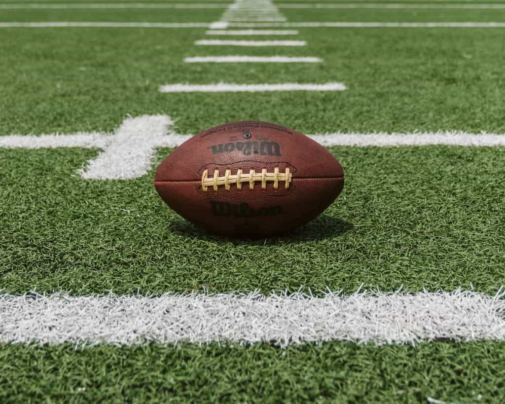 Wilson football rests on NFL field.