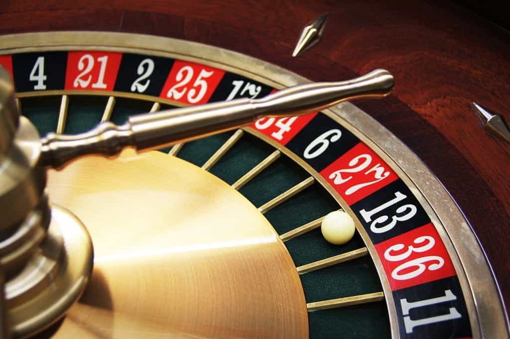 A still roulette wheel, with the ball in the black 13 slot.