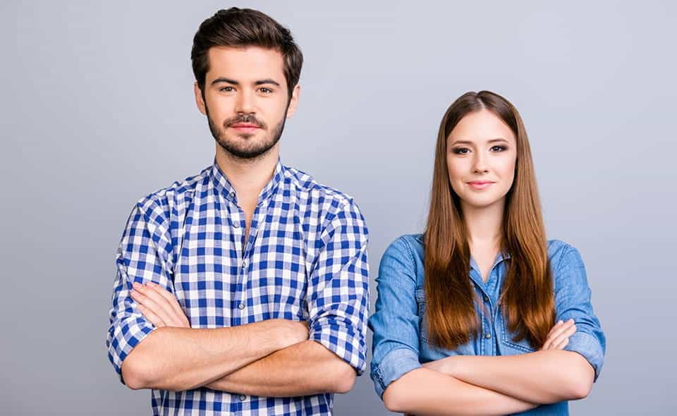 A man wearing a checked shirt and a woman wearing a denim shirt.