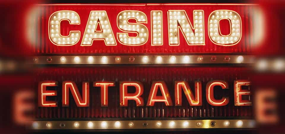 A lit and neon sign saying "Casino Entrance".