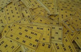 A massive pile of yellow bingo cards.