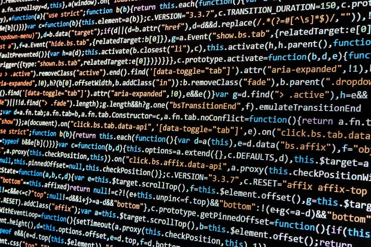 A black computer screen with lines of multicolored code.
