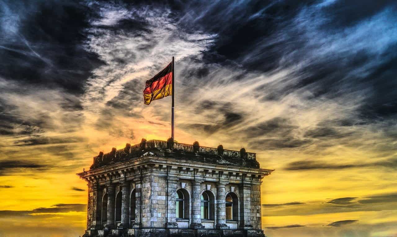 The German flag flying from a building.