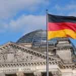 The German flag flying in front of the Reichstag in Berlin.