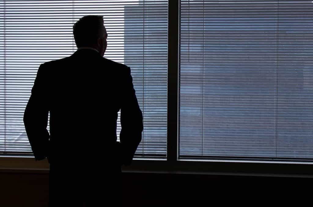 Businessman looking out of window.