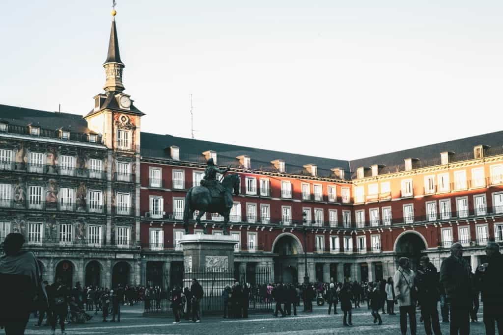 Plaza Mayor in Madrid with a bronze statue of a man on a horse.