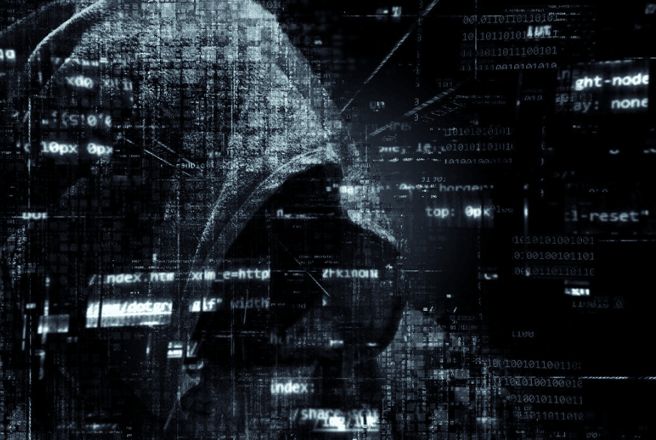 A black screen filled with transparent lines of text. A figure wearing a hood covering their face is in the background.