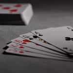 A hand of cards next to a deck of cards.