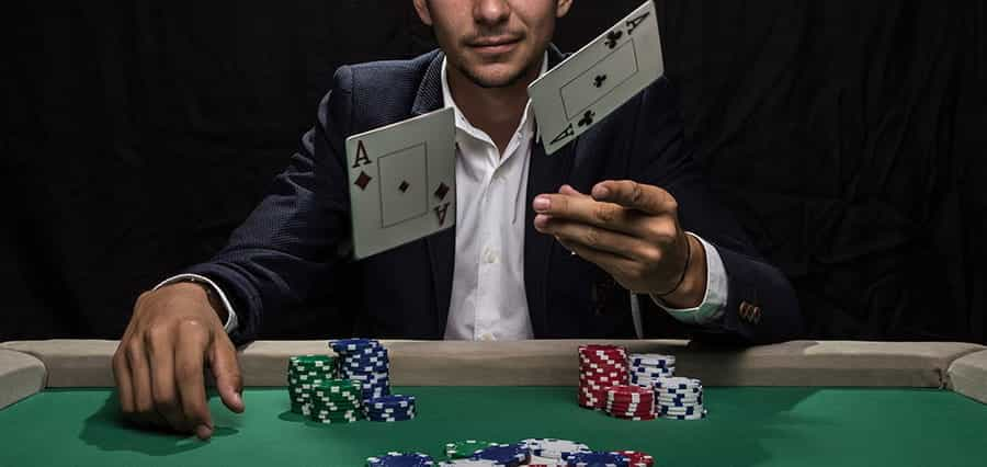 A man flipping cards at the camera.