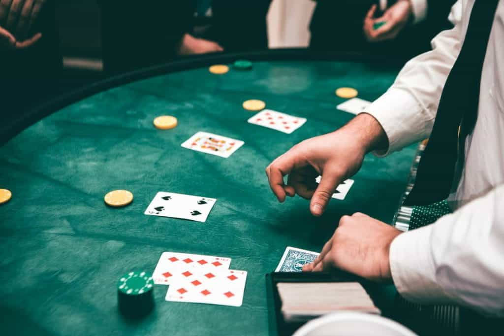 Poker dealer deals cards to players.