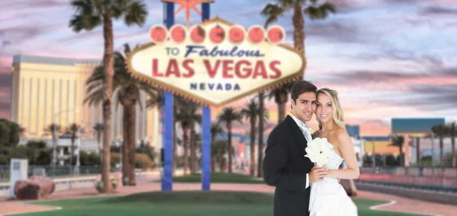 A bride and groom, with the Las Vegas Boulevard in the background.