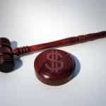 A judge's gavel with a dollar sign.