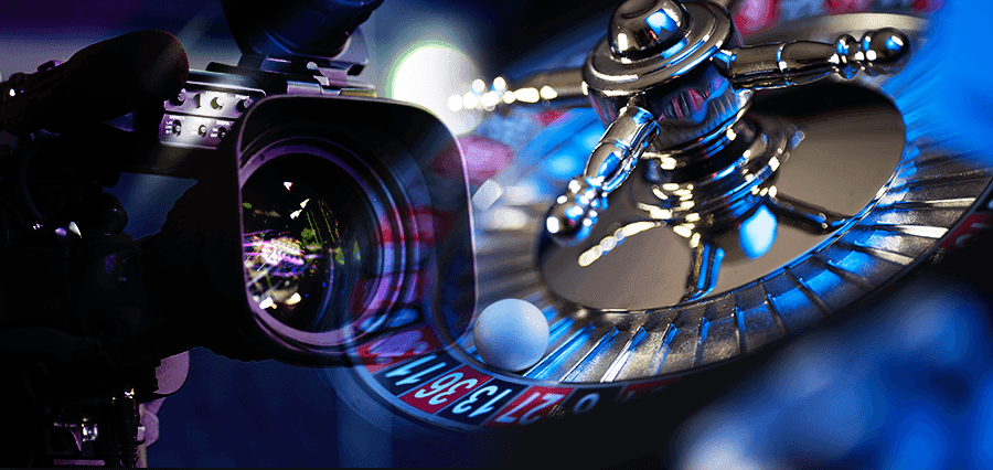 A TV camera next to a roulette wheel.