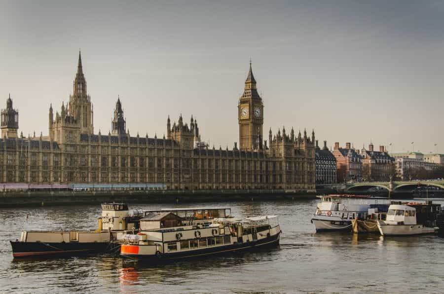 Boats on the river Thames outside London's Houses of Parliament.