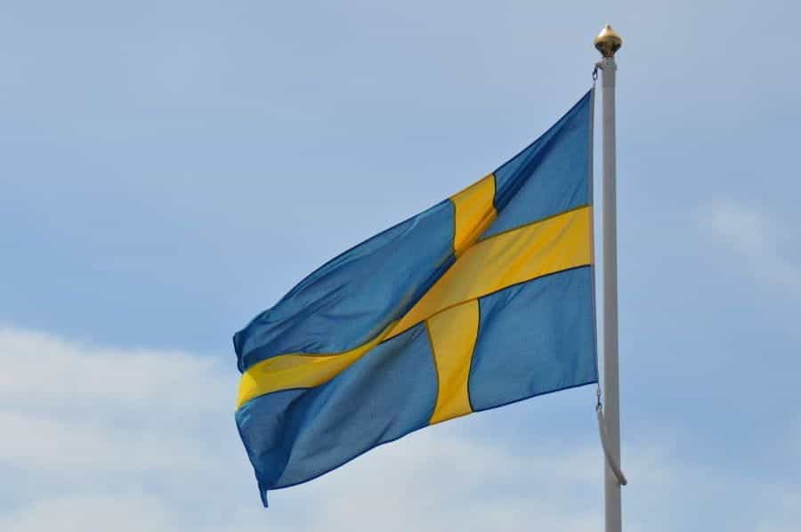 The Swedish flag flying from a flagpole.