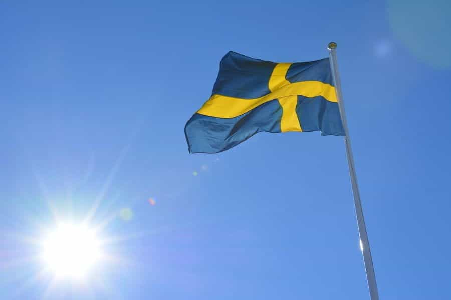 The Swedish flag flying from a flagpole.