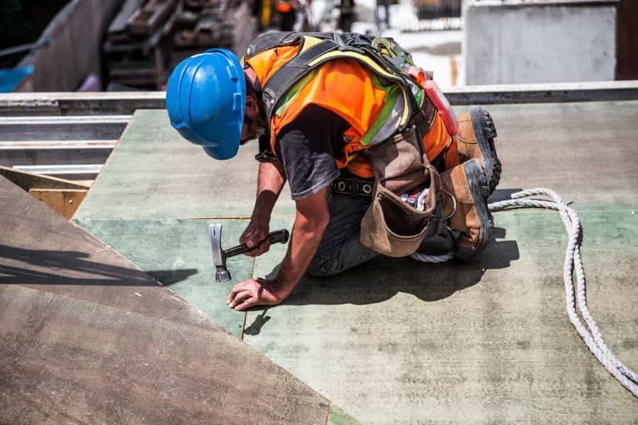 A builder renovates a roof.