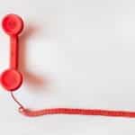 A red charity helpline telephone.