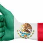 A hand giving a thumbs-up superimposed with the Mexican flag.