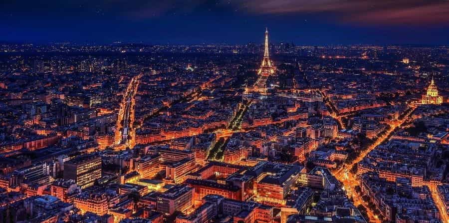 Paris at night time, the Eiffel Tower is clearly visible.