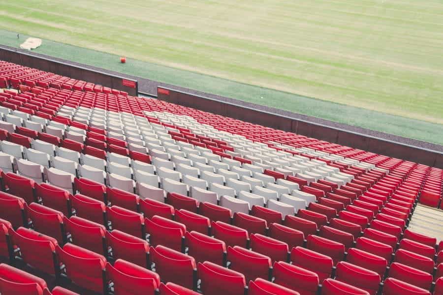Empty red and white seats at a football stadium.